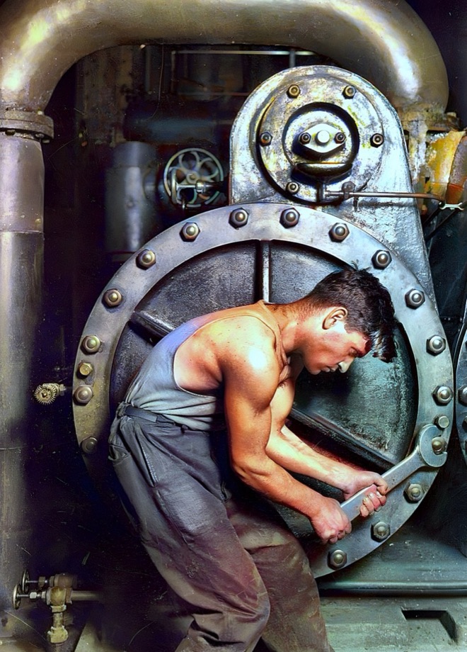 The same 1920 mechanic colorized: warm skin tones against gunmetal machinery and brass pipes
