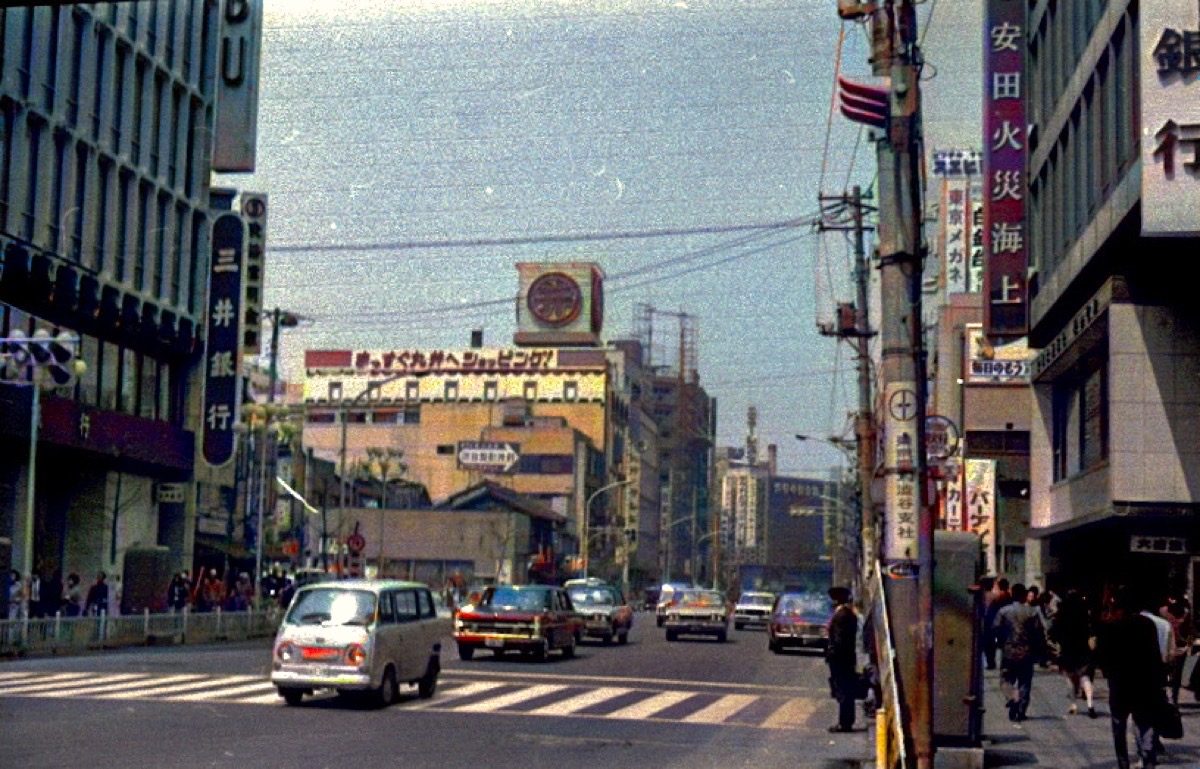 The same 1970 Tokyo street colorized, with natural signage, cars and sky