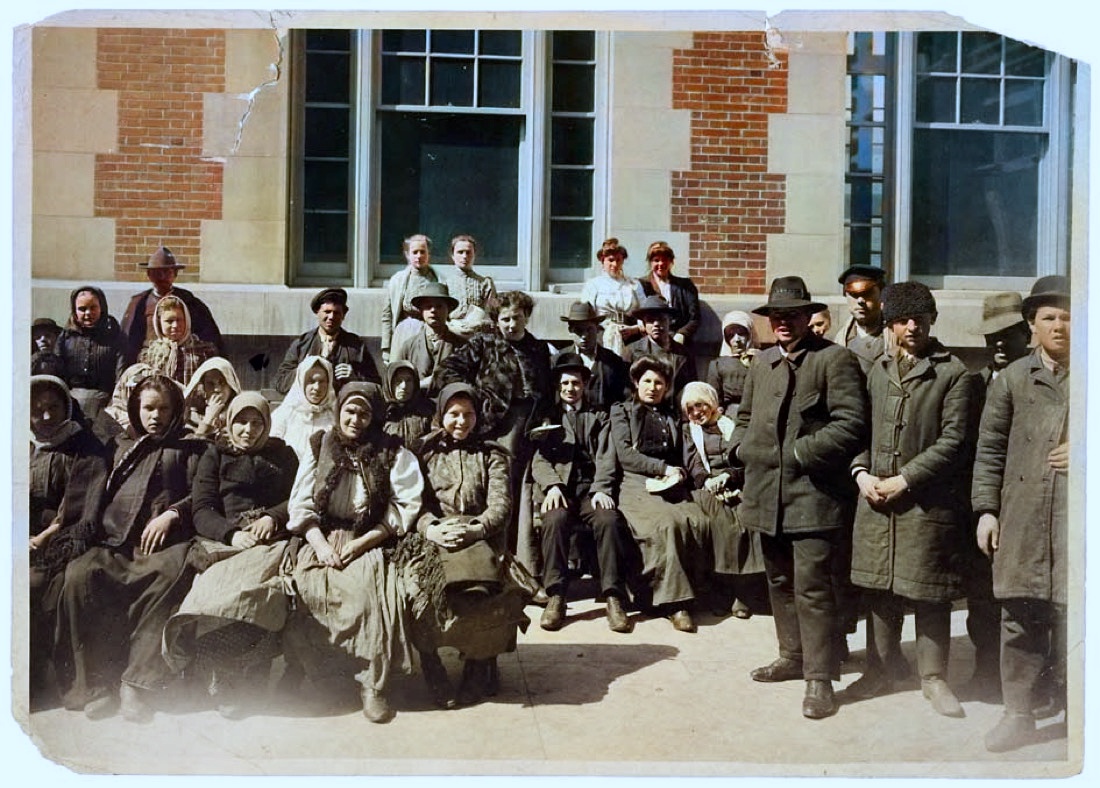 The same Ellis Island group colorized, with warm coats and natural skin tones