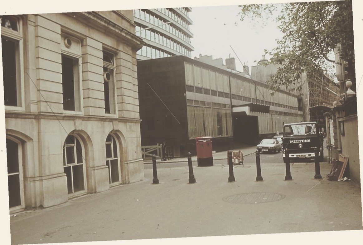 A 1979 London street photograph shot at an oblique angle with faded colour
