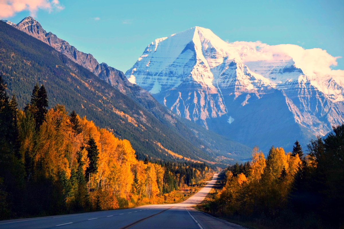 The same Mount Robson landscape with restored colour — snow, blue sky and autumn trees