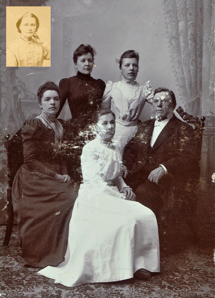 A damaged and faded black-and-white photograph of the Wallin family